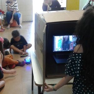 Caja de cartón para que los niños expresen emociones en secreto mientras otros niños intentan descifrar la expresión secreta elegida.